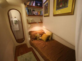 Single bunk located in port hallway with privacy curtain