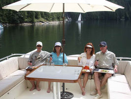 Top Flying Bridge seating area with optional shade umbrella. Always outside, never enclosed.