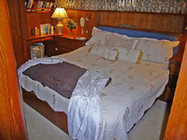 Aft Stateroom with a king size bed, 30" LCD TV, entertainment center, his and hers desks, lots of storage and space
