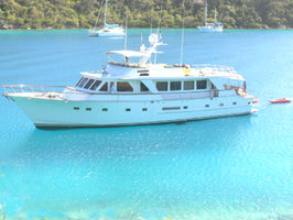 NSS Pattam waiting for you at anchor in the clear crystalline waters of Peter Island, BVI, with some of the water toys deployed