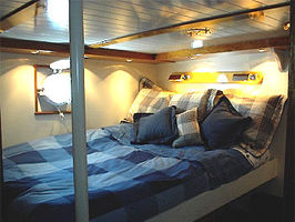 Each of the three staterooms has a queen sized bed in addition to a single bunk. Storage lockers and drawers provide space for personal items to be stowed out of sight, while the ensuite heads (bathrooms) each feature a large shower, sink, counter, toilet, and ample cabinet space. The staterooms each have a porthole that allows for natural lighting during the day while excellent interior lighting is available for reading and relaxing.